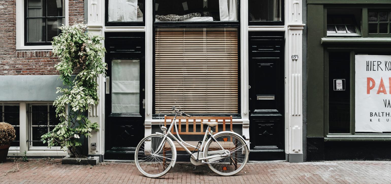bicycle in front of apartment on footpath