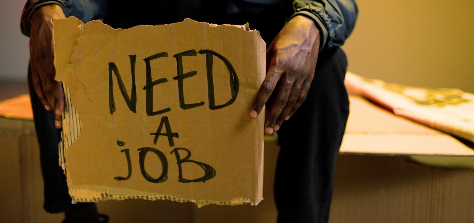 man holding sign need a job