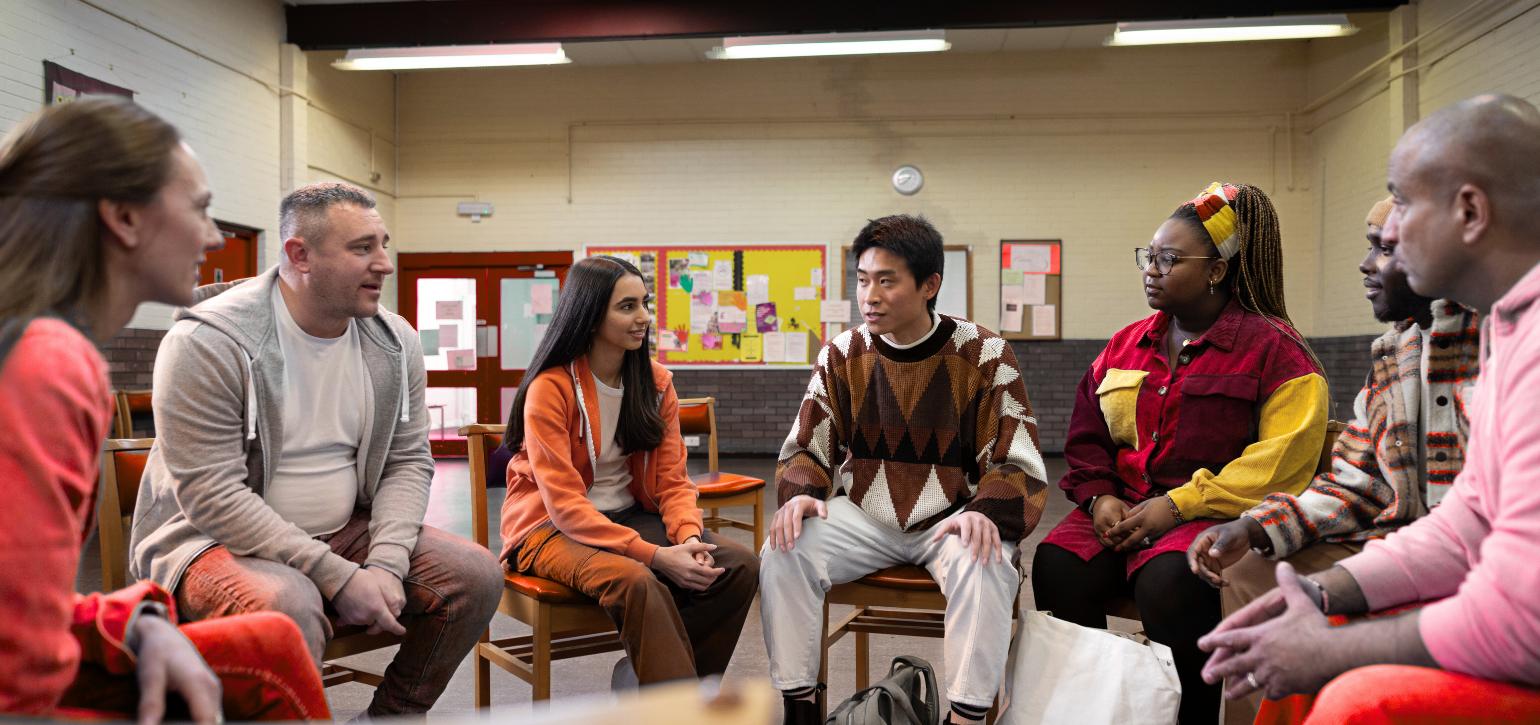 community members seated in a room talking