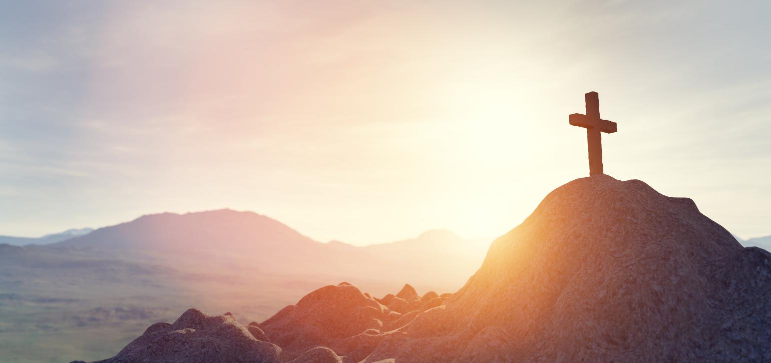 cross on a mountain in sunlight