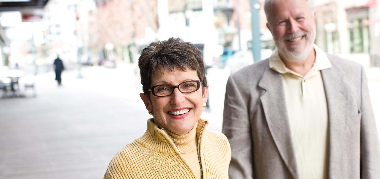 baby boomer couple on the street smiling
