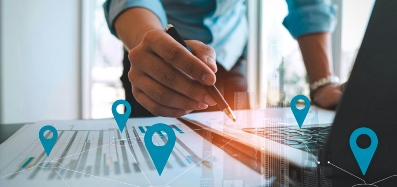 man leaning on a table mapping out locations