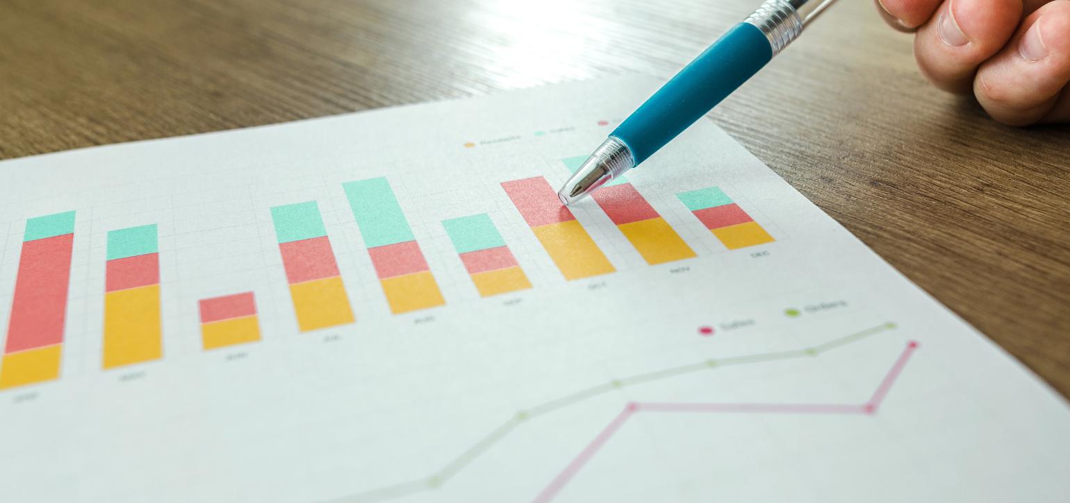 graph on paper with a pen and hand