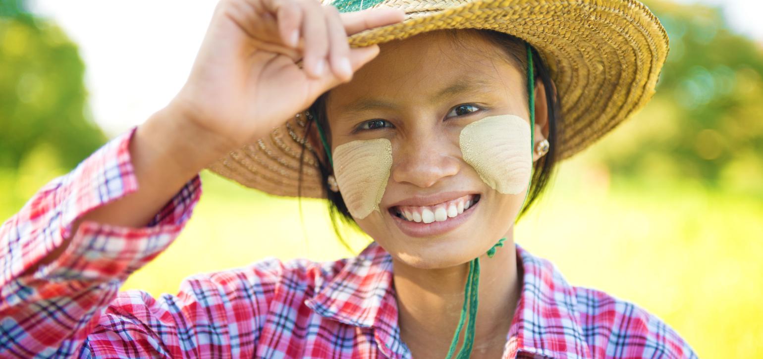 burmese lady with sunscreen and hat smiling