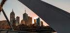 Melbourne skyline photographed from a curving bridge