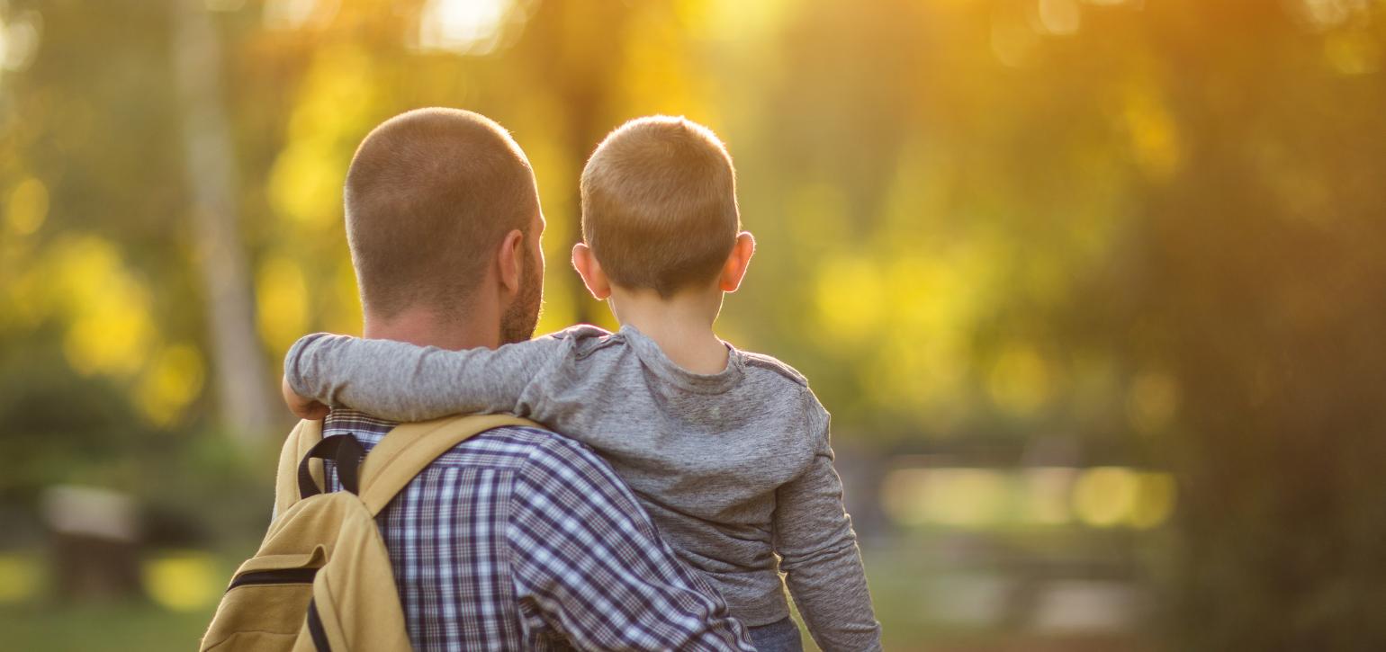 Man with child in park