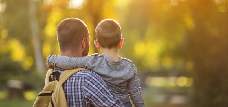 Man with child in park
