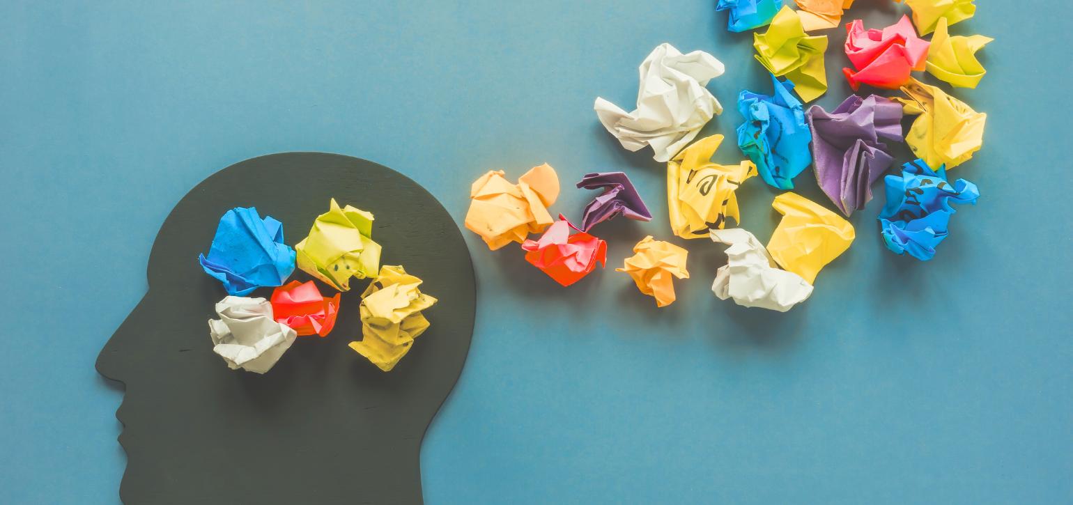 black head with scrunched up coloured paper balls