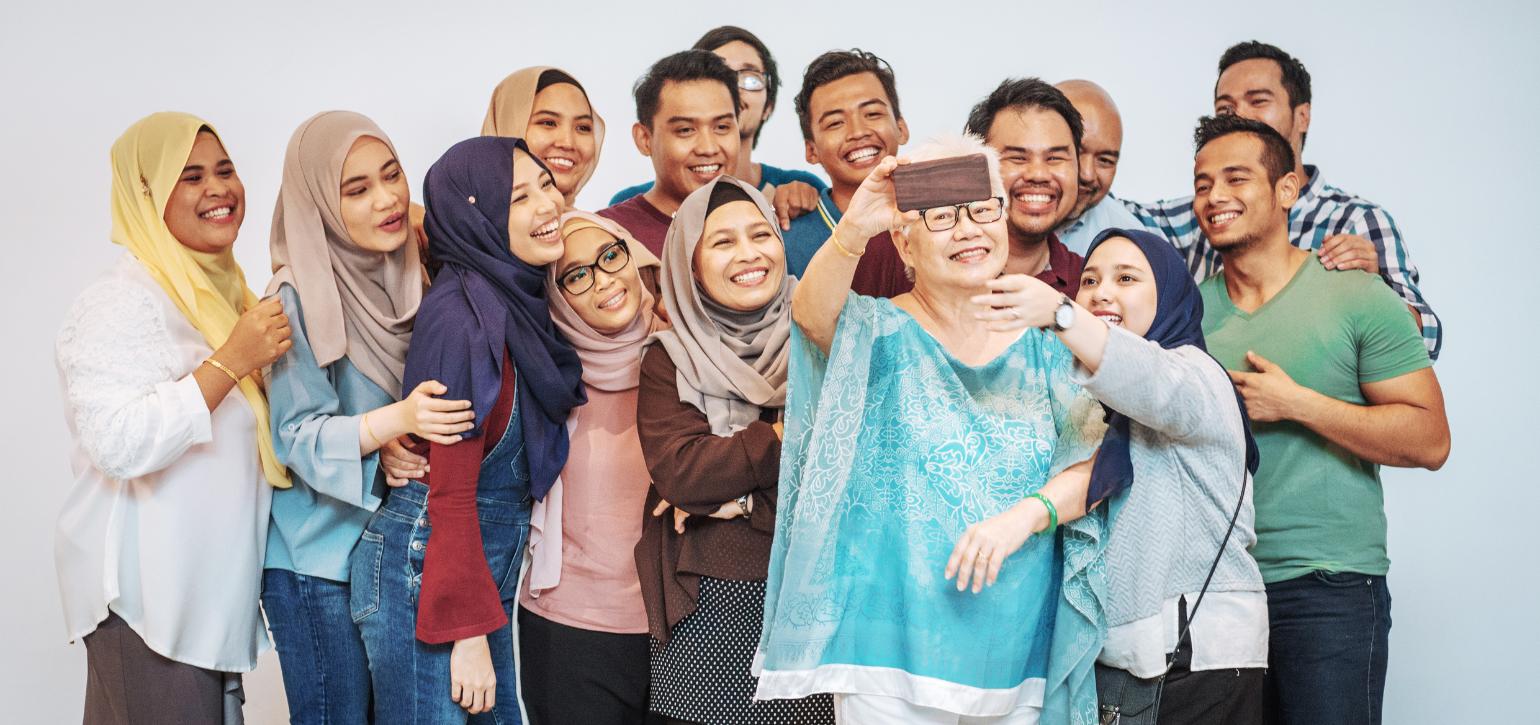 group of new migrants taking a selfiie