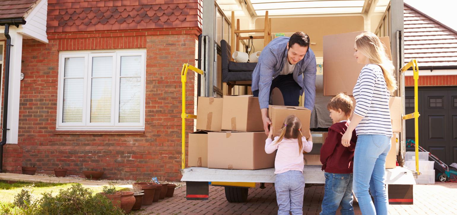family moving house with boxes and truck
