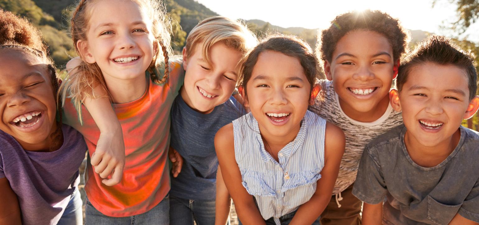 multicultural group of kids at the beach