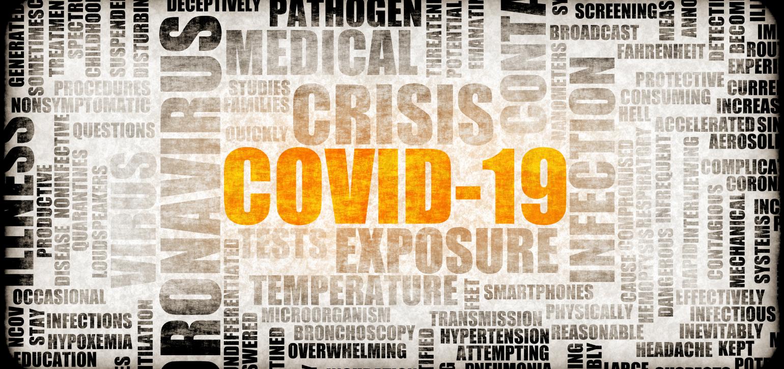 Covid 19 highlighted in newspaper cut out word cloud