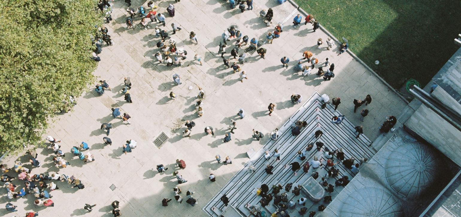 aerial view of people walking outside a building