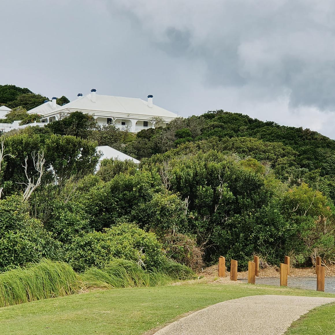 historic house on a hill above a pathway