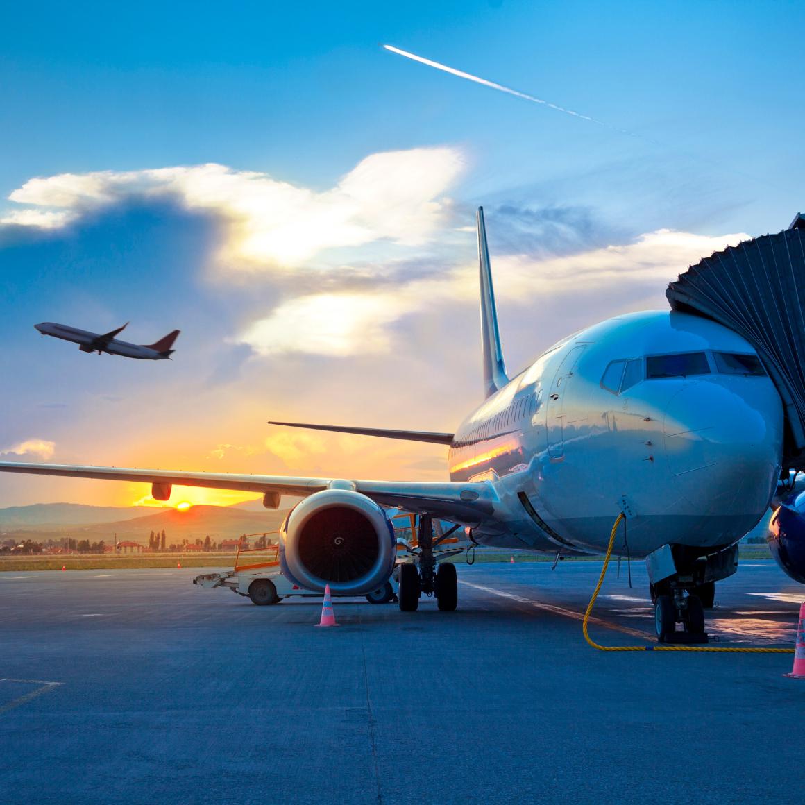 airplane at the gate at sunset