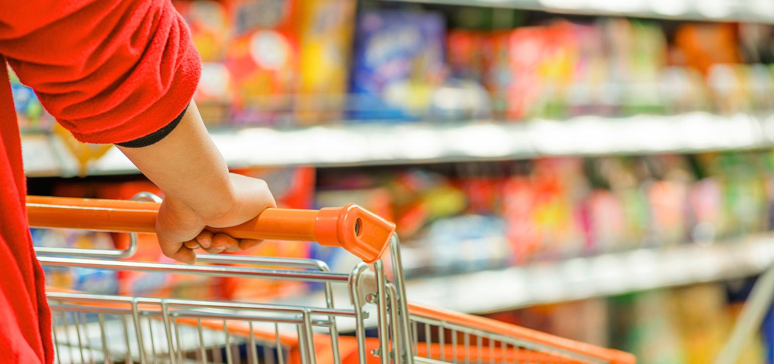 supermarket shelf and woman with trolley